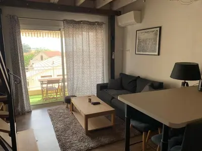 a living room with a couch and a table at Prunete - Appartement - 2 personnes - Piscine in Cervione