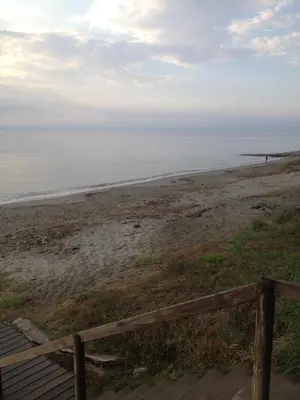 a view of a beach with a wooden fence at Prunete - Appartement - 2 personnes - Piscine in Cervione