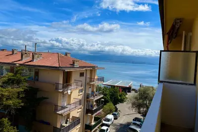 a view of the ocean from a building at Spacious apartment with sea view in Ajaccio