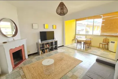 a living room with a fireplace and a tv at Spacious apartment with sea view in Ajaccio