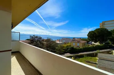a balcony with a view of the ocean at Spacious apartment with sea view in Ajaccio