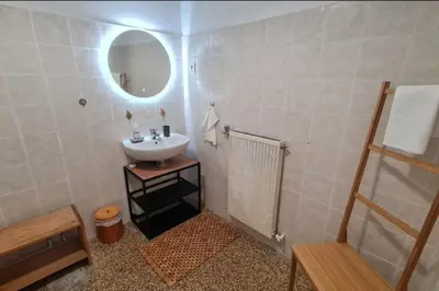 a bathroom with a sink and a mirror at Spacious apartment with sea view in Ajaccio