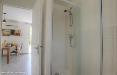 a bathroom with a shower with a glass door at Village Cargese 1 in Cargèse