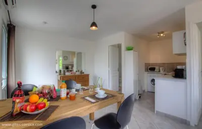 a kitchen with a table with fruit on it at Village Cargese 1 in Cargèse