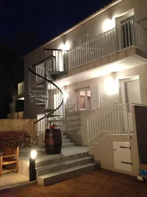 a building with a staircase with a pot on it at Village Cargese 1 in Cargèse