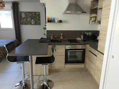 a kitchen with a counter and a stove top oven at Sanguinaires in Ajaccio