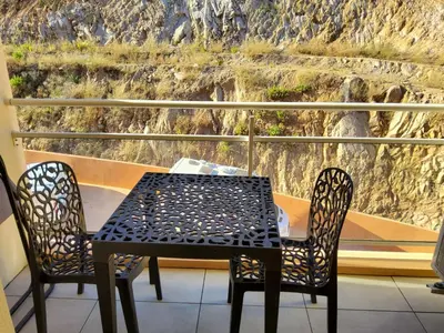 a table and two chairs on a balcony with a view at Sanguinaires in Ajaccio