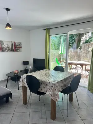a dining table and chairs in a living room at Village Cargèse 2 in Cargèse