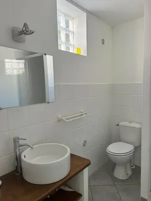 a white bathroom with a sink and a toilet at Village Cargèse 2 in Cargèse