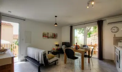 a living room with a table and a dining room at Village Cargèse 2 in Cargèse