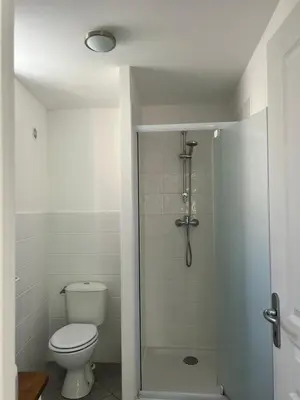a white bathroom with a toilet and a shower at Village Cargèse 2 in Cargèse