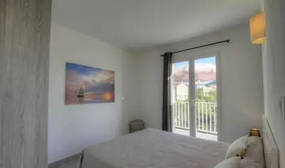 a bedroom with a bed and a large window at Idéal emplacement Cargese 3 in Cargèse