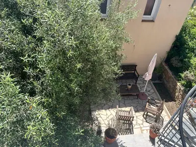 an overhead view of a patio with chairs and a bush at Idéal emplacement Cargese 3 in Cargèse
