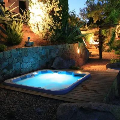 a jacuzzi tub sitting on a wooden deck at Chambre Shelby vue mer avec kitchenette in Porto-Vecchio