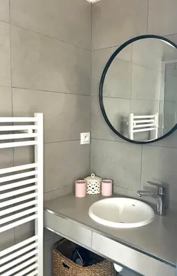 a bathroom with a sink and a mirror at Charmant T3 5 min de porticcio in Porticcio