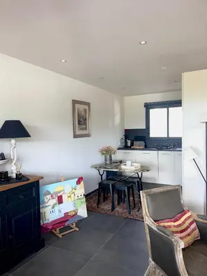 a kitchen with a table and chairs in a room at Charmant T3 5 min de porticcio in Porticcio