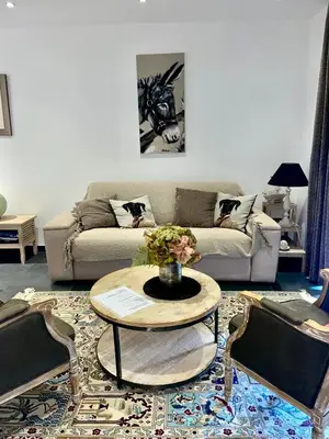 a living room with a couch and a table at Charmant T3 5 min de porticcio in Porticcio