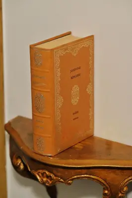a book sitting on top of a wooden shelf at Résidence Mademoiselle Joséphine in Ajaccio
