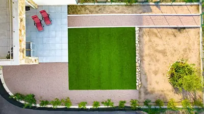 an overhead view of a green yard with red chairs at T3 vue mer 100 m2 de jardin 'D' in Pietrosella
