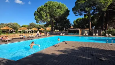 a swimming pool on a deck next to a wooden deck at ALMA Rossa in Lecci