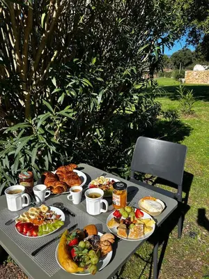 a picnic table with plates of food on it at ALMA Rossa in Lecci
