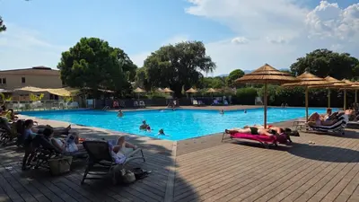 a group of people in the swimming pool at a resort at ALMA Rossa in Lecci