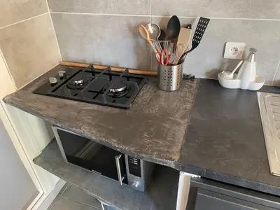 a kitchen counter top with a stove top oven at Proche Ajaccio maisonnette indépendante 4 personnes au calme in Alata