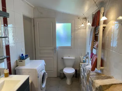 a bathroom with a white toilet and a sink at Proche Ajaccio maisonnette indépendante 4 personnes au calme in Alata