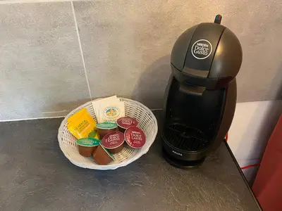 a coffee maker next to a basket of cupcakes at Proche Ajaccio maisonnette indépendante 4 personnes au calme in Alata