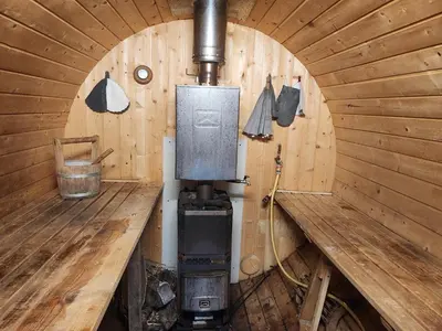 an inside of a wooden cabin with a stove at La chambre d'Aphrodite avec jacuzzi vue mer in Porto-Vecchio