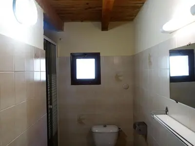 a bathroom with a toilet and a window at Apartment Residence Cabanaccia 3 Pieces 6 Pers-2 by Interhome in Serriera