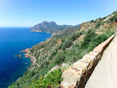 a retaining wall on a cliff next to the ocean at Apartment Residence Cabanaccia 3 Pieces 6 Pers-2 by Interhome in Serriera