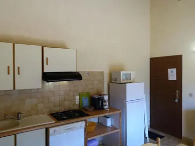 a kitchen with a white refrigerator and a sink at Apartment Residence Cabanaccia 3 Pieces 6 Pers-2 by Interhome in Serriera