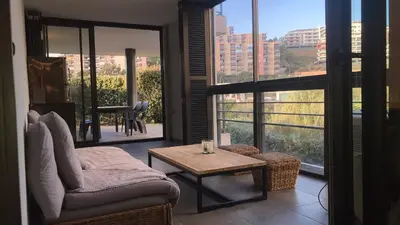 a living room with a couch and a table at T2 standing Ajaccio in Ajaccio