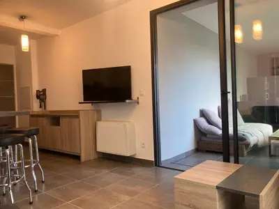 a living room with a flat screen tv on the wall at T2 standing Ajaccio in Ajaccio