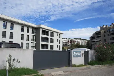 a fence in front of a white building at T2 standing Ajaccio in Ajaccio