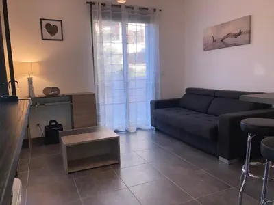 a living room with a couch and a table at T2 standing Ajaccio in Ajaccio
