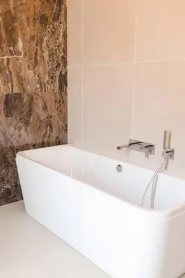 a bathroom with a white tub and a sink at Villa luxe avec piscine et belle vue mer in Pietrosella