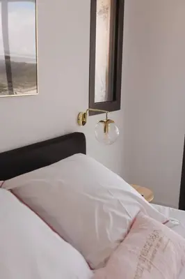 a bed in a room with a window and a bedsheet at Villa luxe avec piscine et belle vue mer in Pietrosella