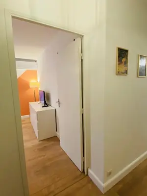 a hallway with a door leading to a room with a laptop on a desk at Lisandrina in Ajaccio