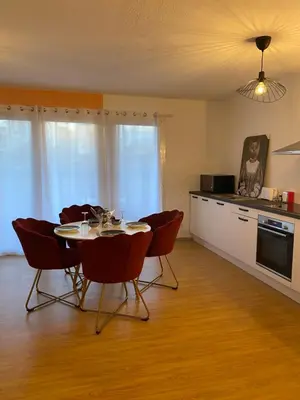 a kitchen with a table and chairs in a room at Lisandrina in Ajaccio
