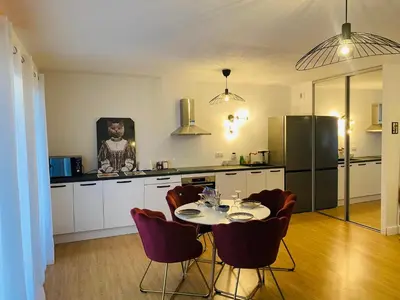 a kitchen with a table and chairs and a refrigerator at Lisandrina in Ajaccio