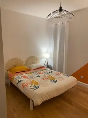 a bedroom with a bed with a colorful blanket at Lisandrina in Ajaccio