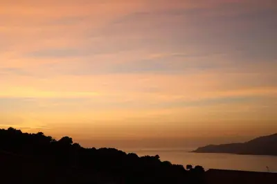 a sunset over a body of water at CHEZ ADRIEN 108-Appartement magnifique vue mer piscine chauffée in Serra-di-Ferro