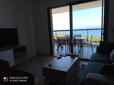 a living room with a couch and a table at La Civita Piétrosella in Pietrosella