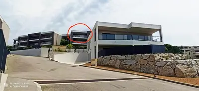 a building with a red circle on the side of it at La Civita Piétrosella in Pietrosella