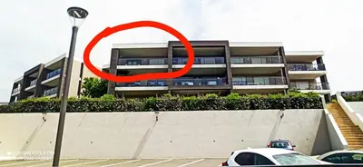 a red circle on the side of a building at La Civita Piétrosella in Pietrosella