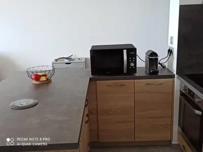 a kitchen with a black microwave on a counter at La Civita Piétrosella in Pietrosella