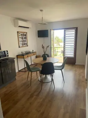 a kitchen and dining room with a table and chairs at Appartement proche du départ du GR20 in Calenzana