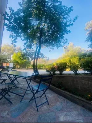 a table and chairs sitting in front of a tree at Calenzana GR20 in Calenzana